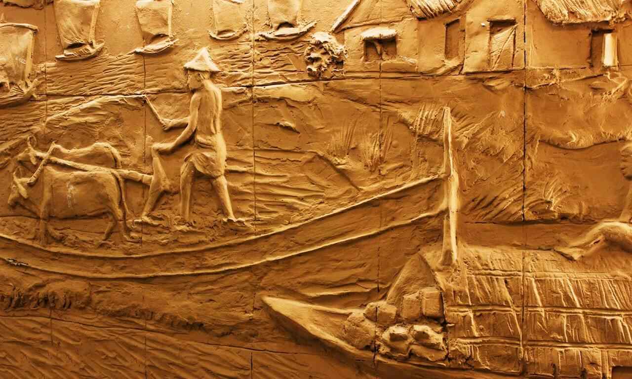 A carving of a boat with people on it