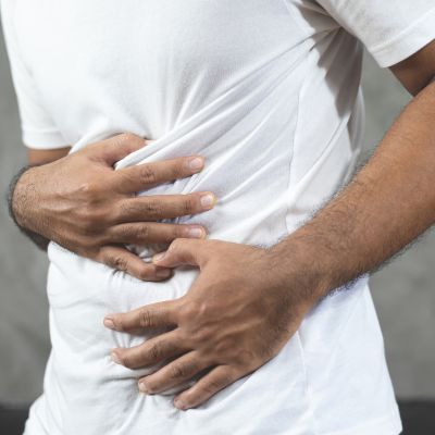 man holding his stomach in pain